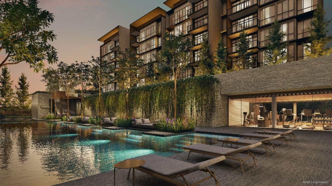 Lakeside pool at Amberwood at Holland with sun loungers, a green cascading planted wall and the glazed gymnasium alongside the pool deck