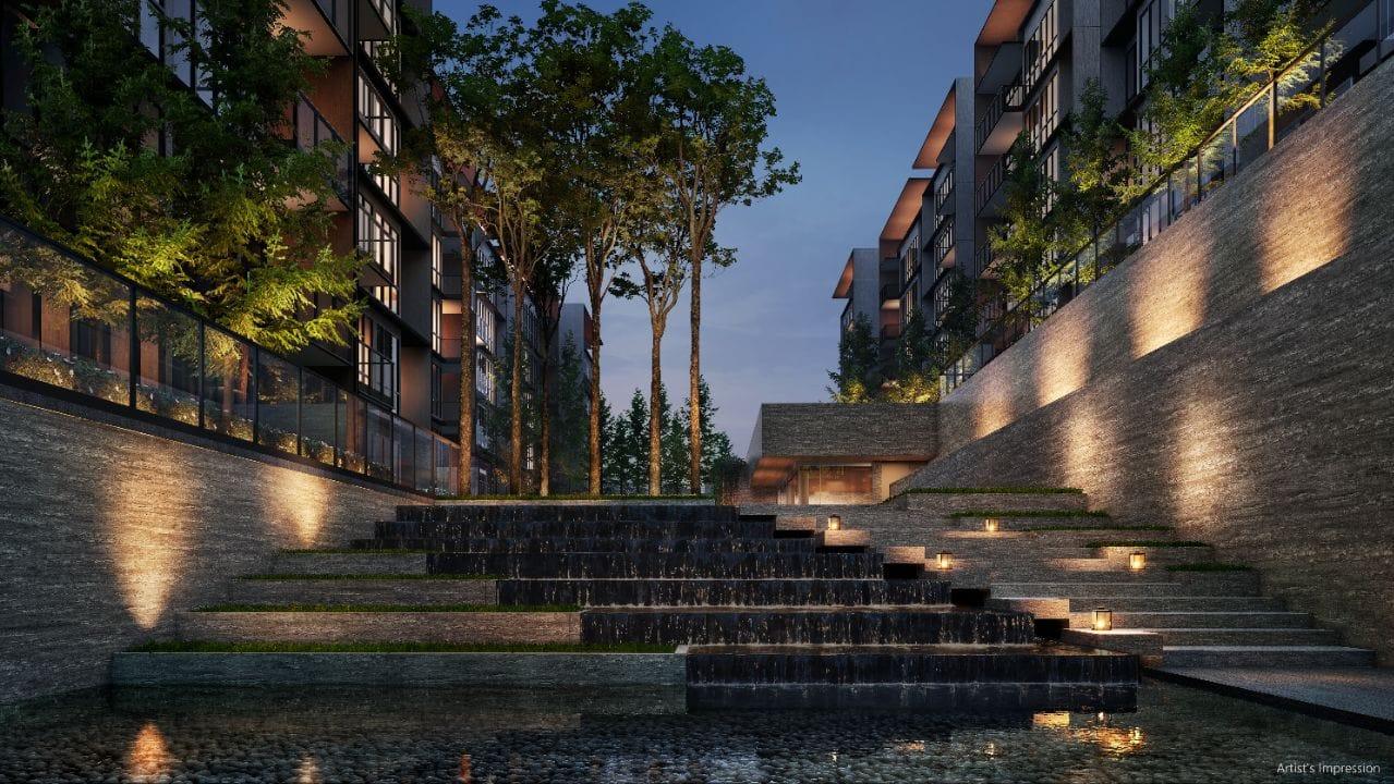 Water terrace at Amberwood at Holland, a stepped cascade running between two residential blocks with lit stone retaining walls and mature trees