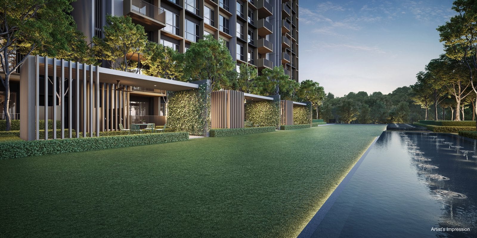 The Grand Boulevard at Coastal Cabana EC at dusk, with cabana pavilions, a green wall and the reflecting pool alongside the lawn