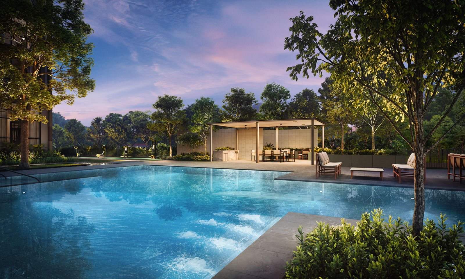 The family pool and BBQ Pavilion at The Sen at dusk, with mature trees, sun loungers and the Sen Club pavilion beyond